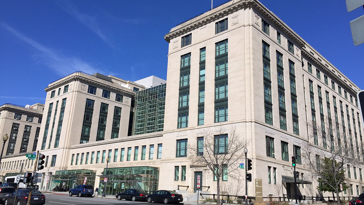 Angle view of white stone governmental building against a bright blue sky